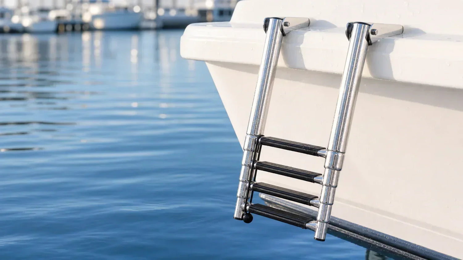 Polished stainless steel telescoping boat ladder mounted on a boat transom at a marina.