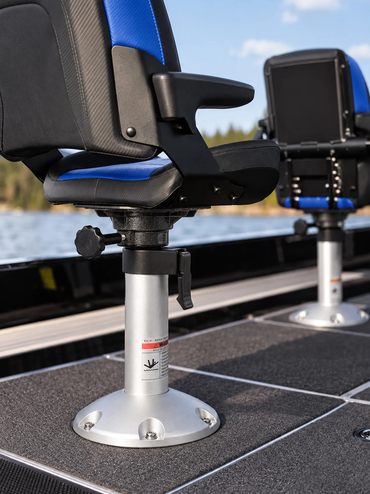 Black and blue fishing boat seat mounted on a silver adjustable pedestal, with a second seat in the background.