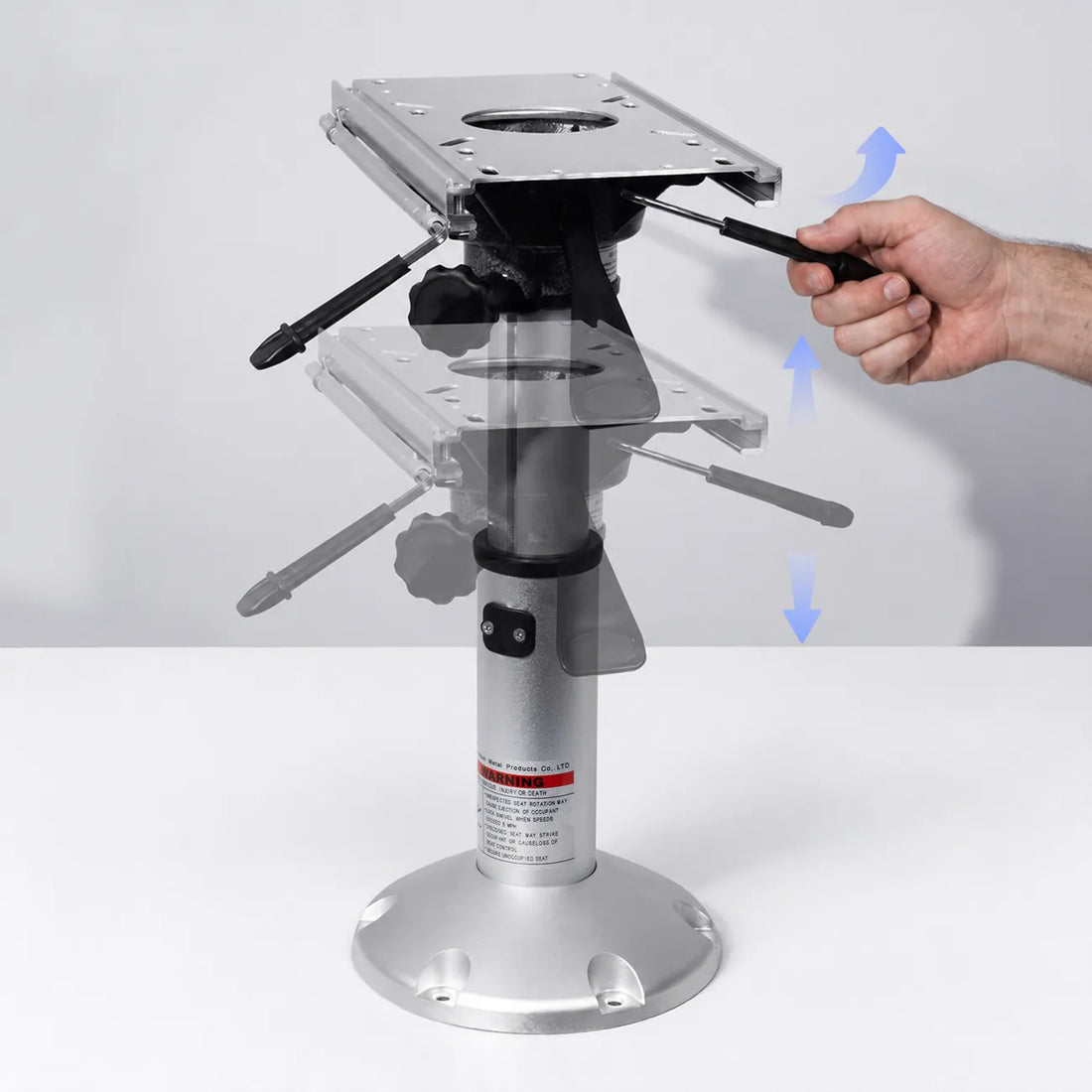 Hand operating the adjustment lever on a silver boat seat pedestal with slide mount and height arrows.