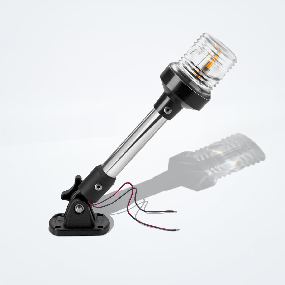 Marinexplore 9-inch anchor light with a polished chrome pole and clear ribbed lens glowing warm white, mounted on a black folding base with wire leads, photographed at an angle on a light gray studio backdrop.
