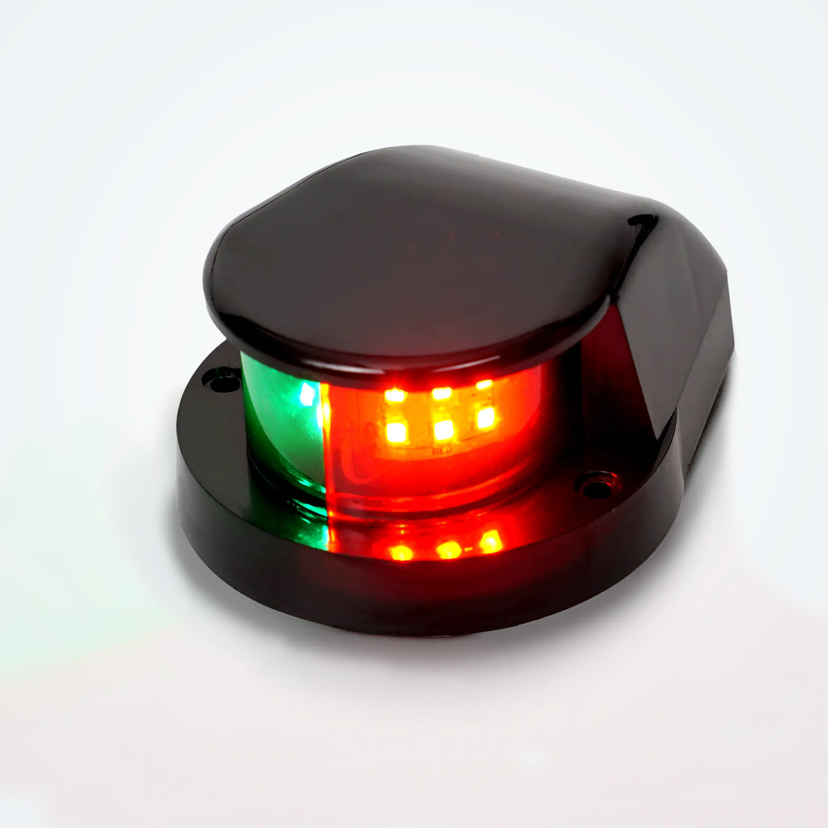 Marinexplore black ABS boat bow navigation light with a teardrop-shaped dome housing and two mounting screw holes on the black base, photographed at a three-quarter angle showing the illuminated green and red bicolor lens against a light gray studio backdrop.