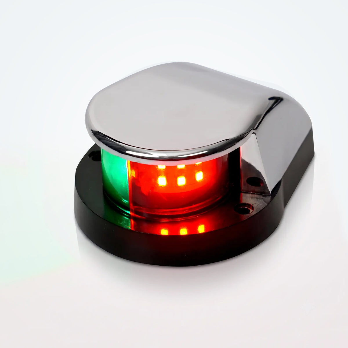 Marinexplore silver ABS boat bow navigation light with a teardrop-shaped dome housing and two mounting screw holes on the black base, photographed at a three-quarter angle showing the illuminated green and red bicolor lens against a light gray studio backdrop.