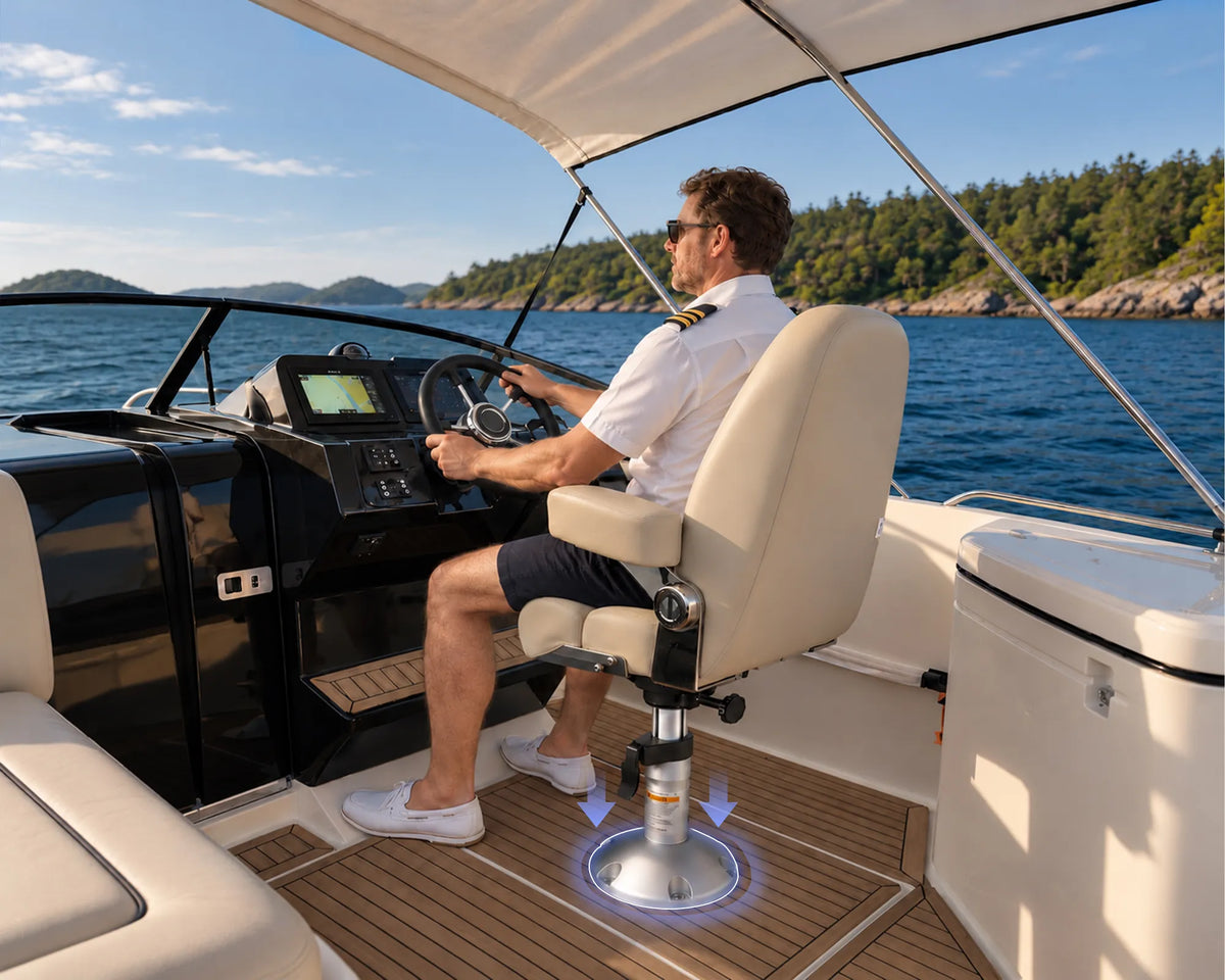 White captain's seat mounted on a silver boat seat pedestal beside the helm, shown from the side.