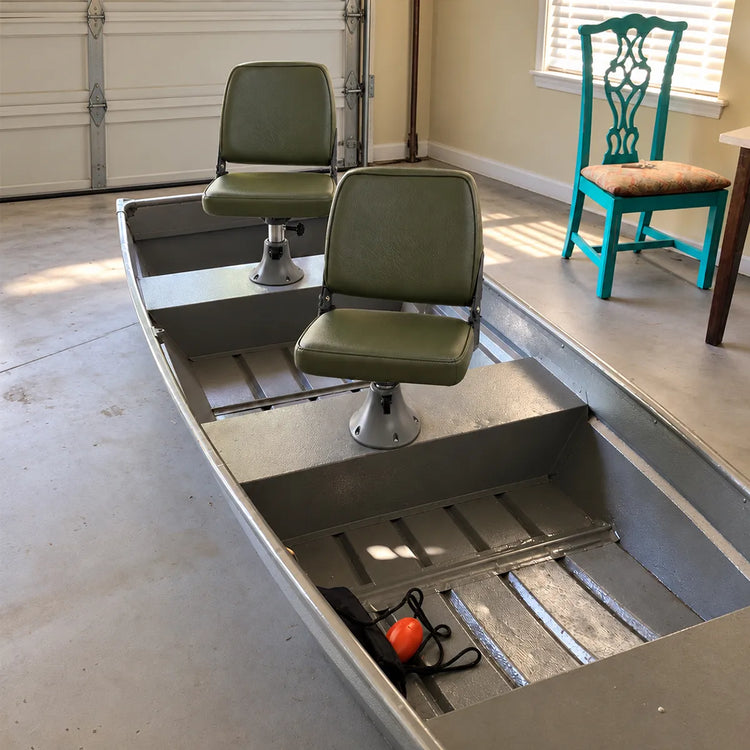 Customer-installed green fishing seats on silver boat seat pedestals inside an aluminum boat.