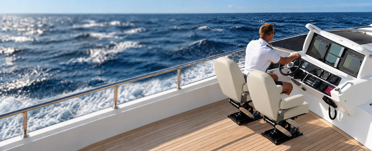 Two white captain's seats mounted on boat seat pedestals beside the helm of a motorboat underway at sea.