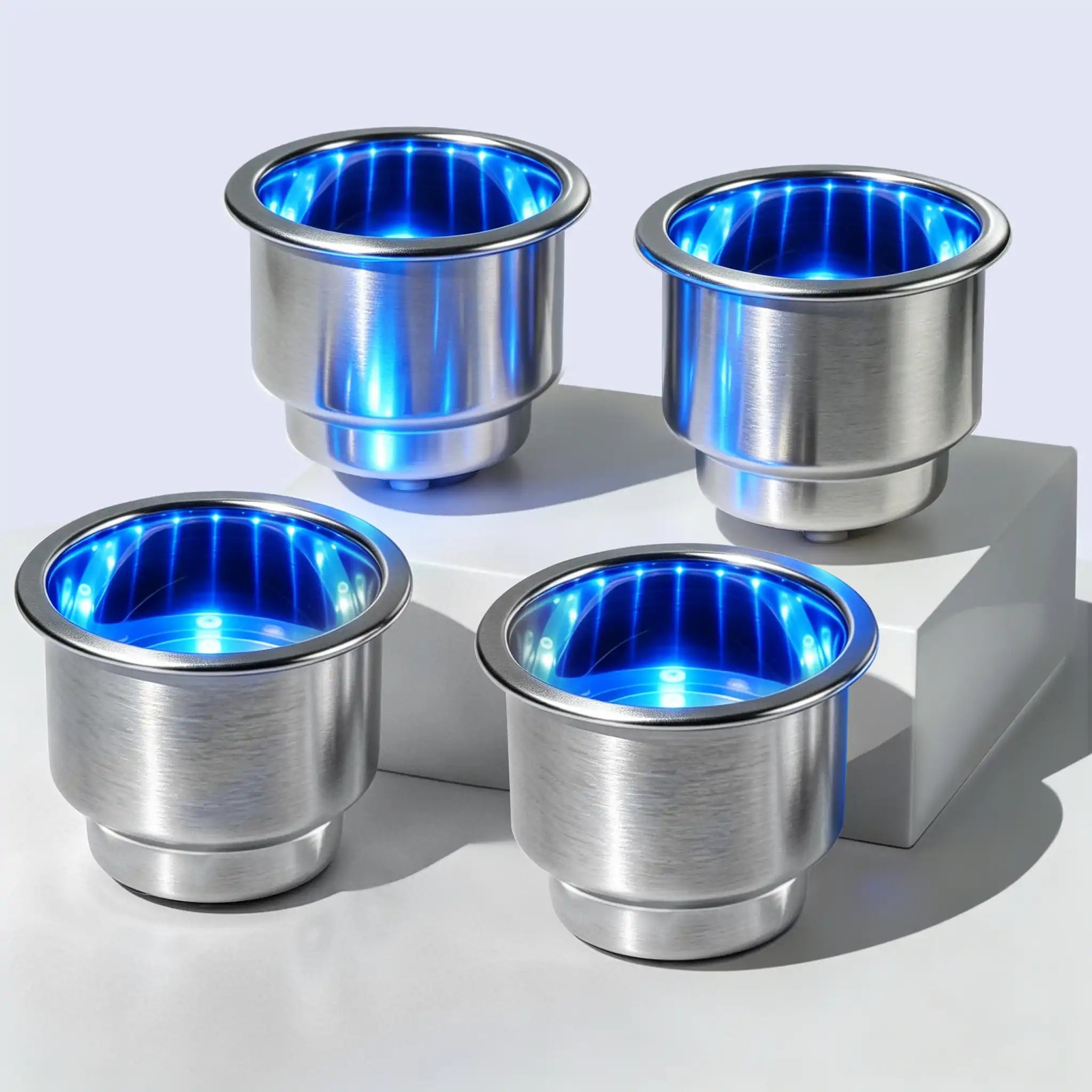 Set of four Marinexplore stainless steel LED boat cup holder inserts lit in blue.