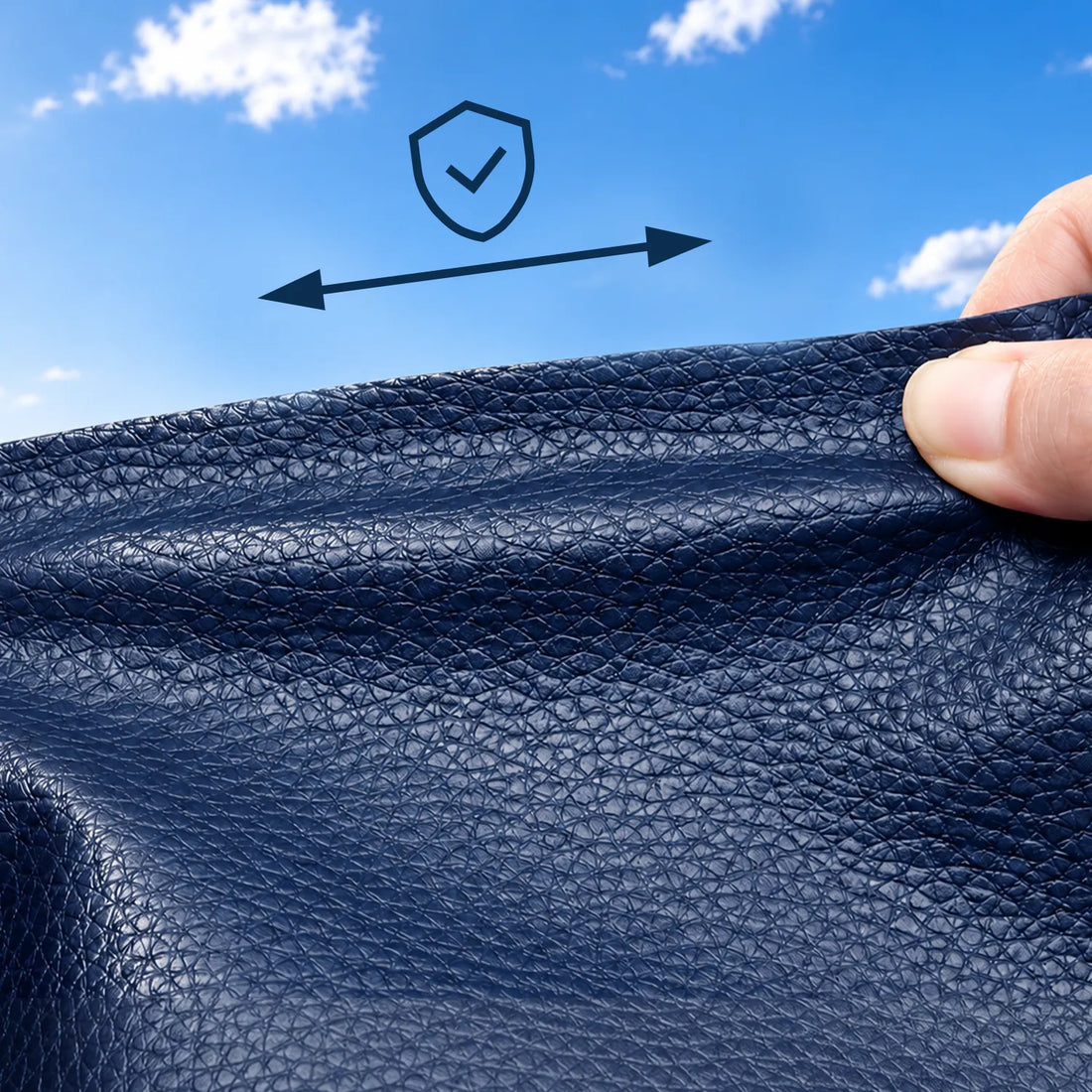 Hands stretching dark blue marine vinyl to show its flexible, durable surface.