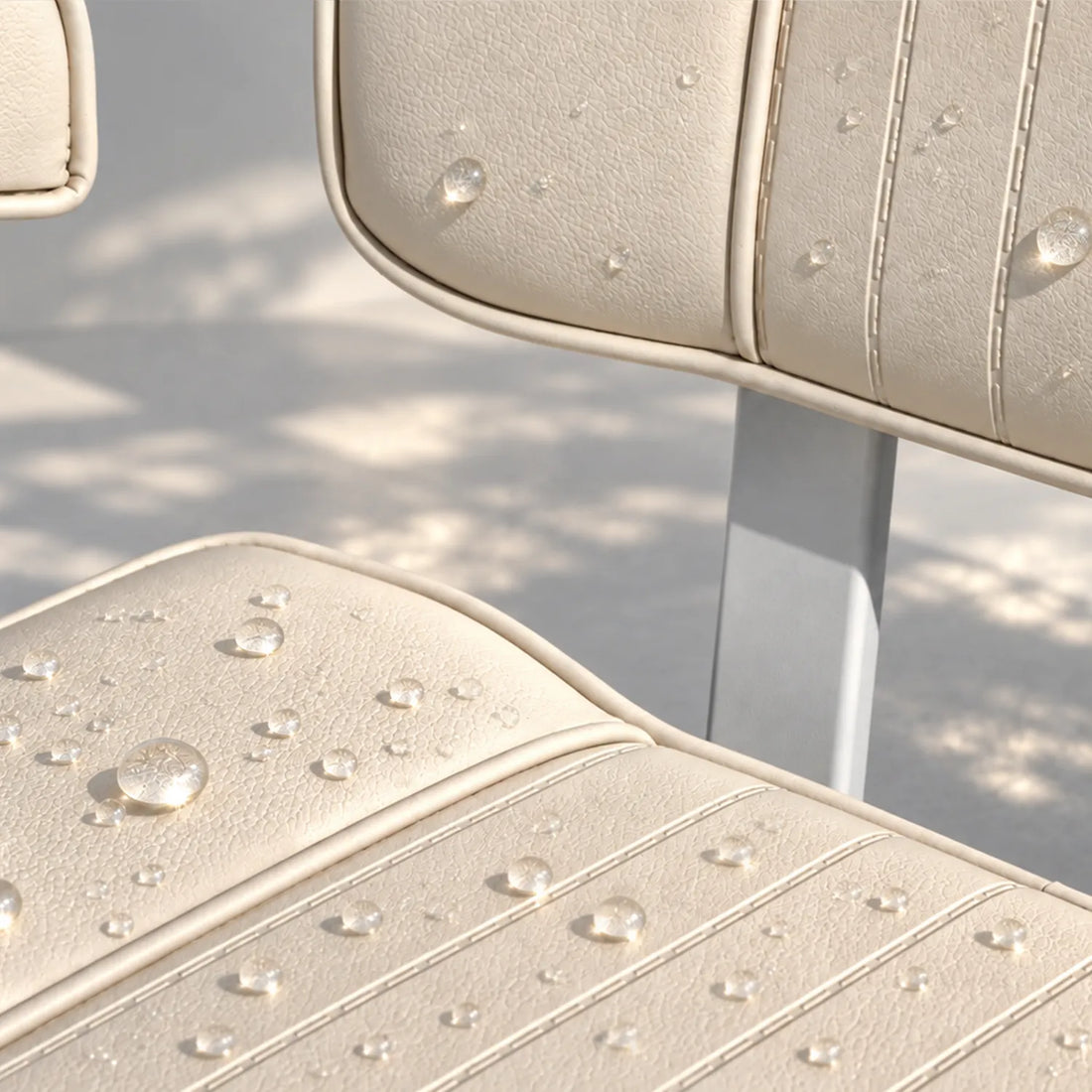 Close-up of water beading on beige marine vinyl upholstery with stitched channels.